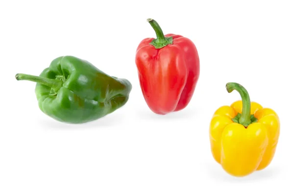 Yellow, green and red peppers on a white background — Stockfoto
