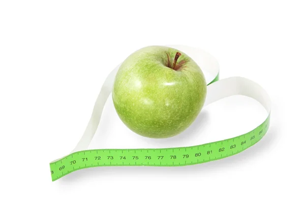 Measuring tape a heart-shaped with a green apple — Stock Photo, Image