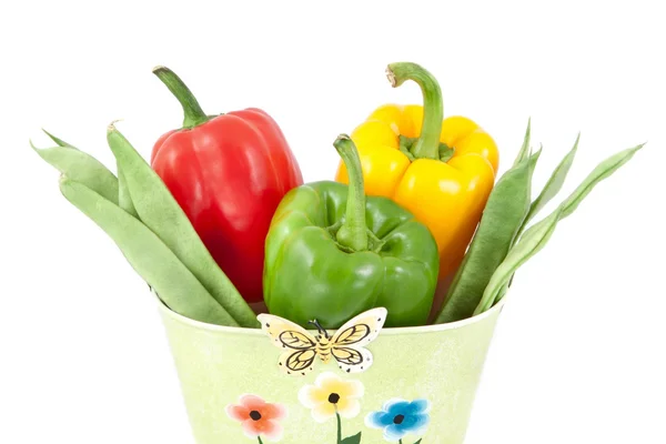 Green beans with yellow, green and red peppers on a white backgr — Stockfoto