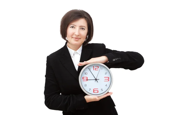 A girl shows a clock. — Stock Photo, Image
