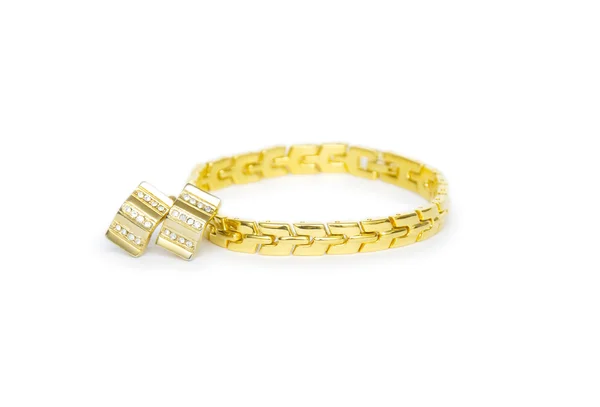 Gold bracelet and earrings isolated on the white — Stock Photo, Image