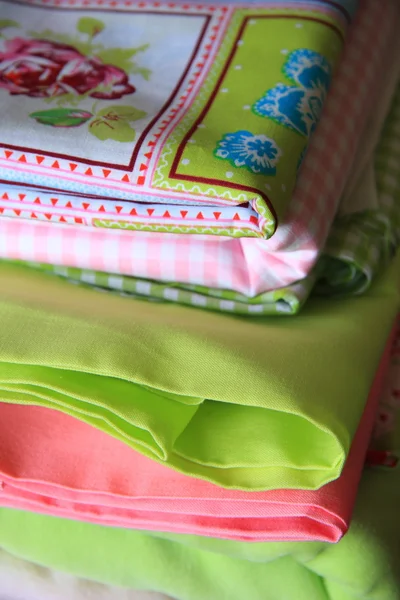 stock image Stack of linen in green and pink