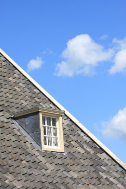 Rooftop with window and a blue sky clipart