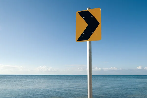 Yellow traffic sign at sea — Stock Photo, Image