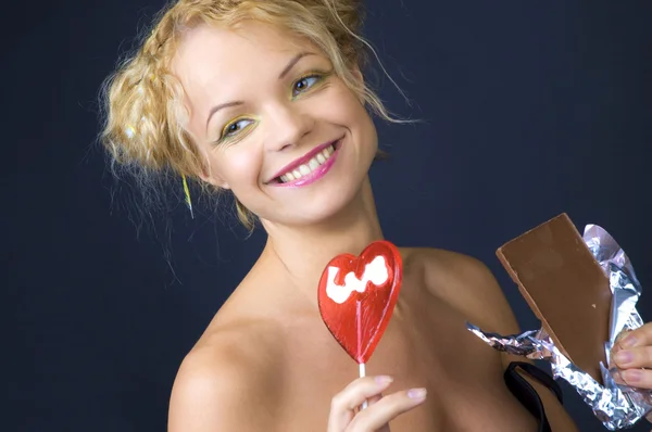 Beauty girl with candy and chocolate — Stock Photo, Image