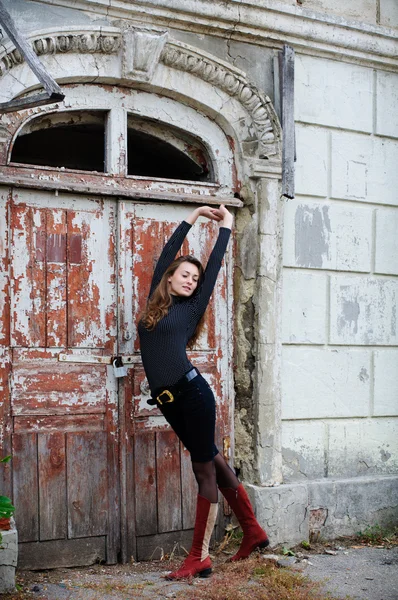 stock image Young woman near old house