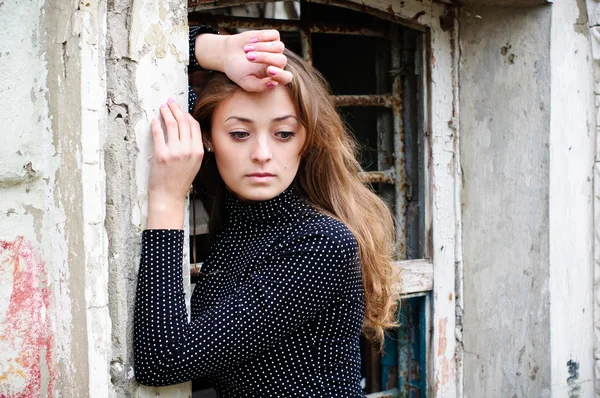 stock image Girl near old window