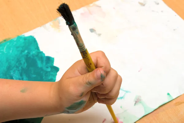 stock image A kid's hand with paintbrush