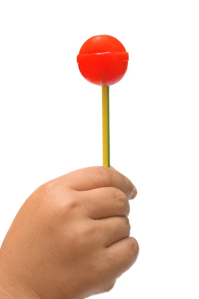 Lollipop in the hand of a child — Zdjęcie stockowe
