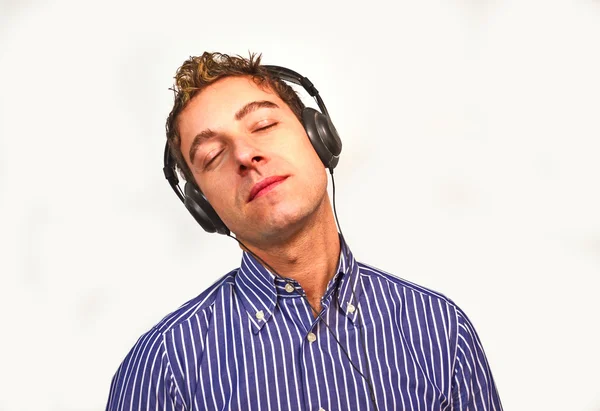 Attractive young man listening to music — Stock Photo, Image