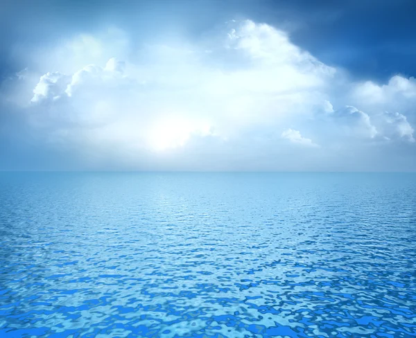 Blue ocean with white clouds on horizon Royalty Free Stock Images