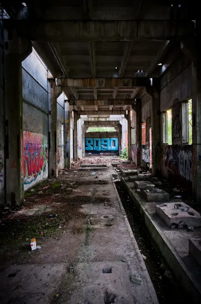 Abandoned building tunnel with graffiti — Stock Photo, Image