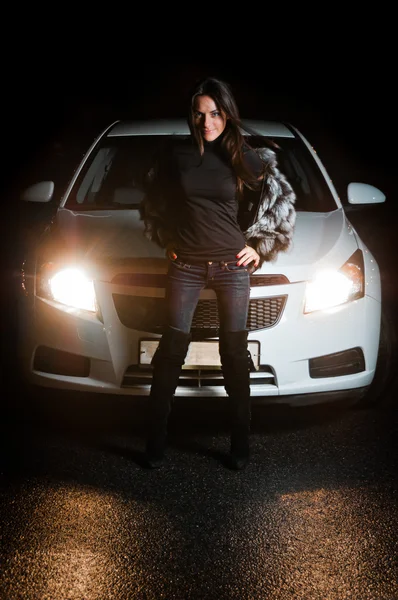 stock image Pretty girl in front of car