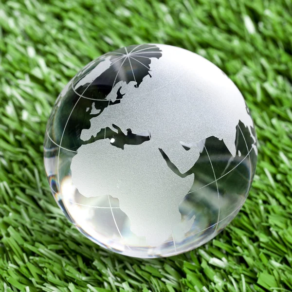 Globus erdball geo karte glas kristal blau fussball rasen — Stockfoto