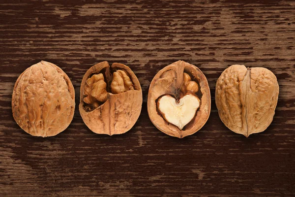 Walnuts on brown wooden background — Stock Photo, Image