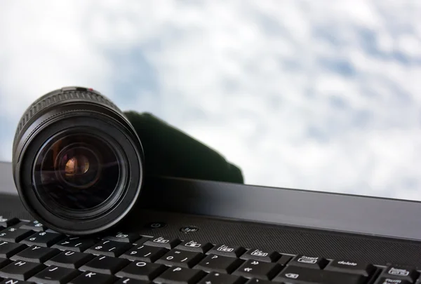 stock image SLR lens over a Laptop Keyboard