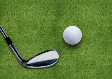 Golf ball and putter on green grass clipart