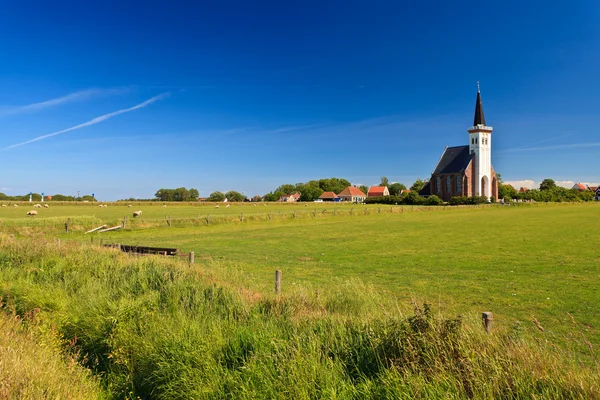Church with grassland on a sunny day — Stock Photo, Image