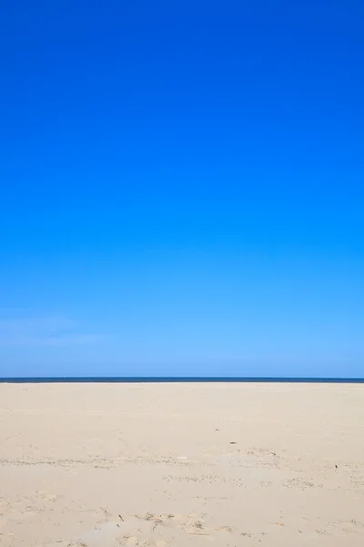A blue clear sky with beach and ocean