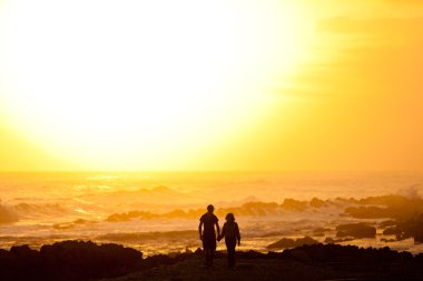 Couple walking on the beach clipart