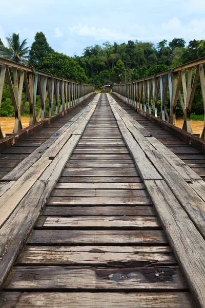 stock image Old bridge over a brown river