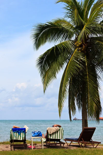 Pár relaxaci na pláži tropického ostrova — Stock fotografie