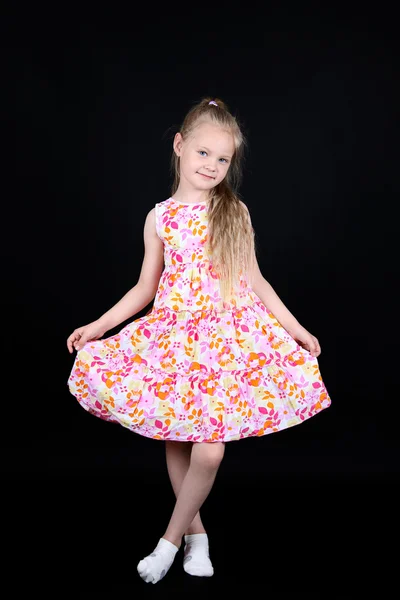stock image Child showing dress isolated on black background