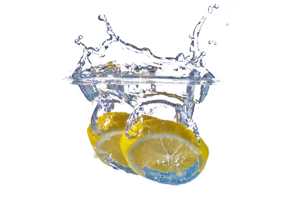 stock image Closeup abstract yellow lemon splashing in clear blue water - is
