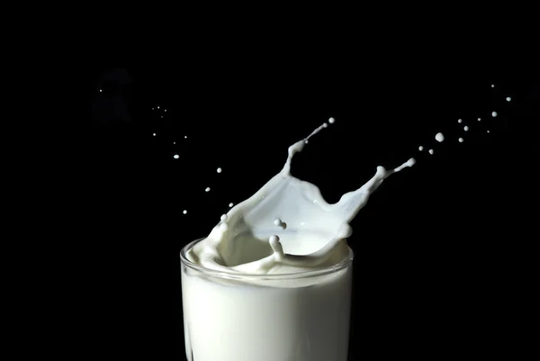 stock image Abstract milk splash against black background