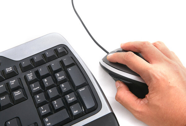Isolated ergonomic keyboard and hand on mouse shot over white background