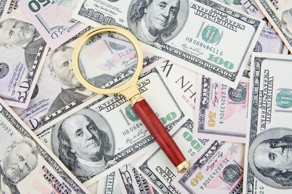 Magnifier and US Banknotes — Stock Photo, Image