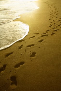 Footprints at sunrise clipart