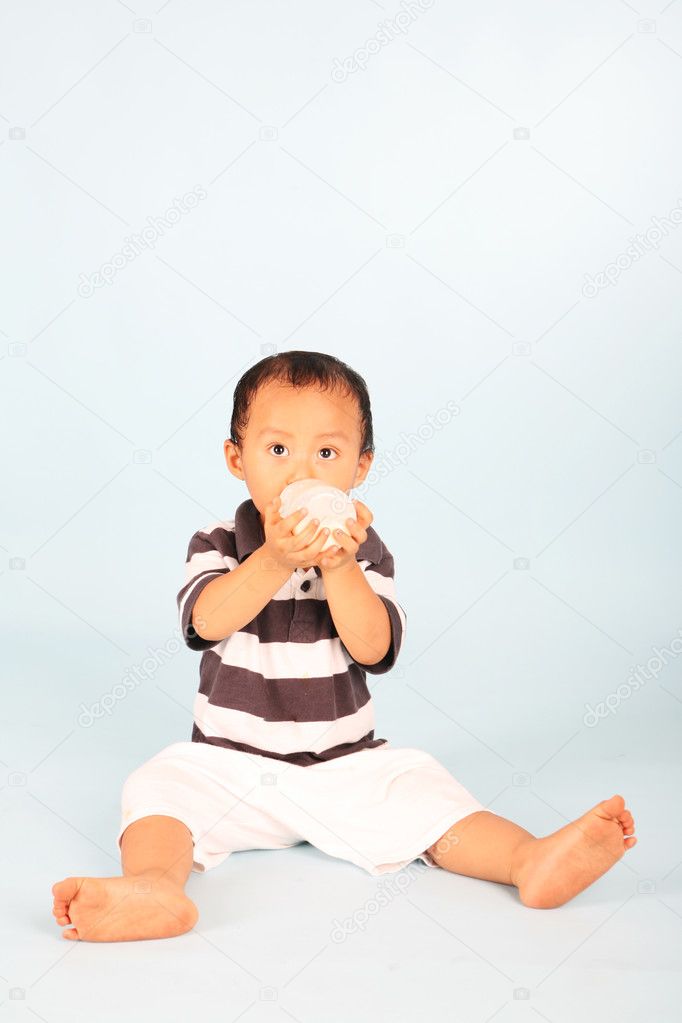 Cute toddler drinking milk