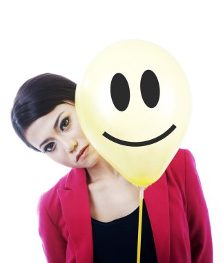 Attractive sad businesswoman behind a smiley face clipart