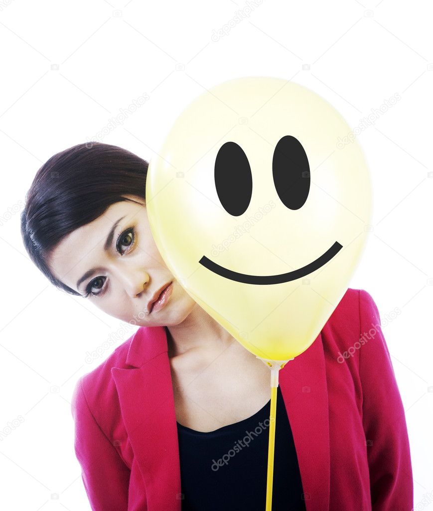 Attractive sad businesswoman behind a smiley face