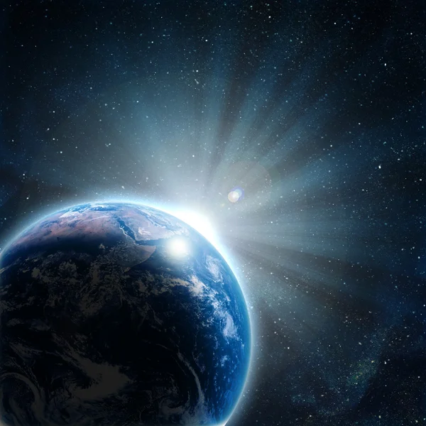 Blue earth in space with rising sun — Stock Photo, Image