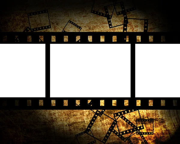 Film pieces on grunge background — Stock Photo, Image