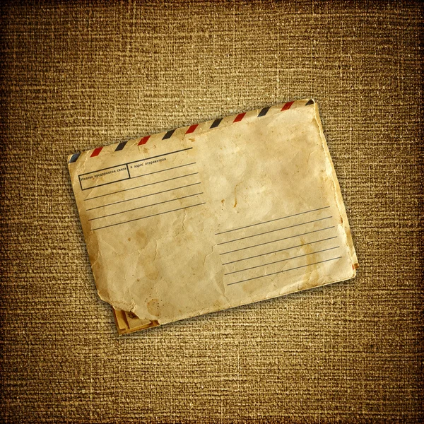 Vintage envelop on brown canvas — Stock Photo, Image