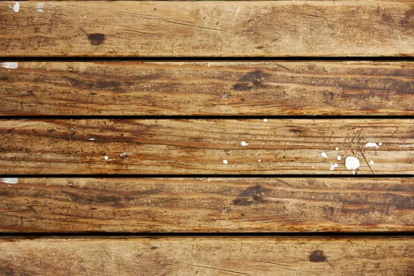 Hnědá textura dřeva s bílým kapkami barvy — Stock fotografie