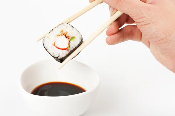 stock image About to put delicious makizushi in soy sauce