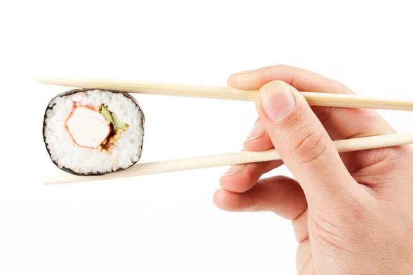Sushi in a hand on a white background — Stock Photo, Image