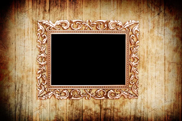 Ancient style golden photo image frame on wood background — Stock Photo, Image