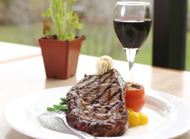 Rib Eye Steak served with wine clipart