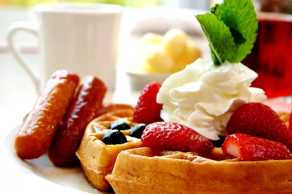 Blueberry waffles with strawberries and sausages — Stock Photo, Image