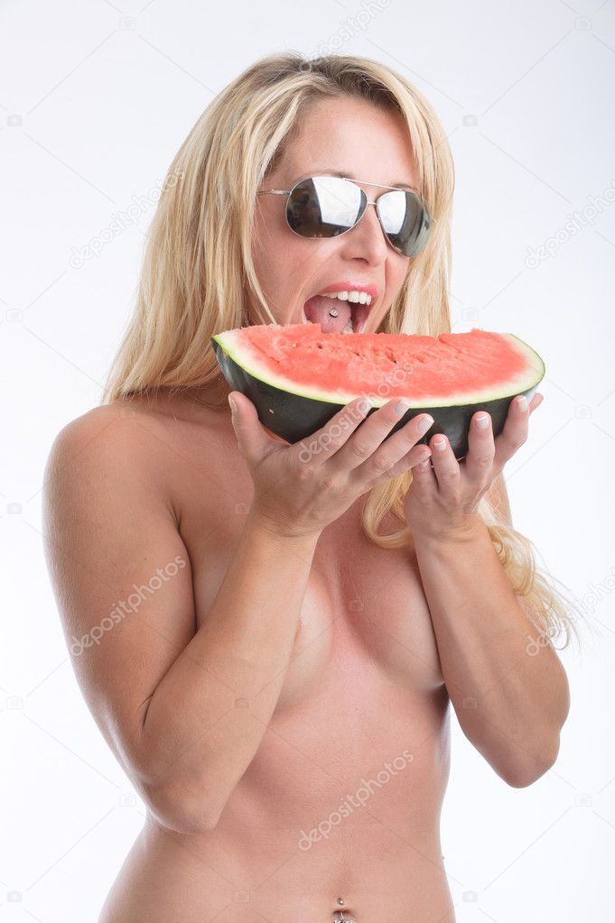 Woman in sunglasses eating a slice of watermelon