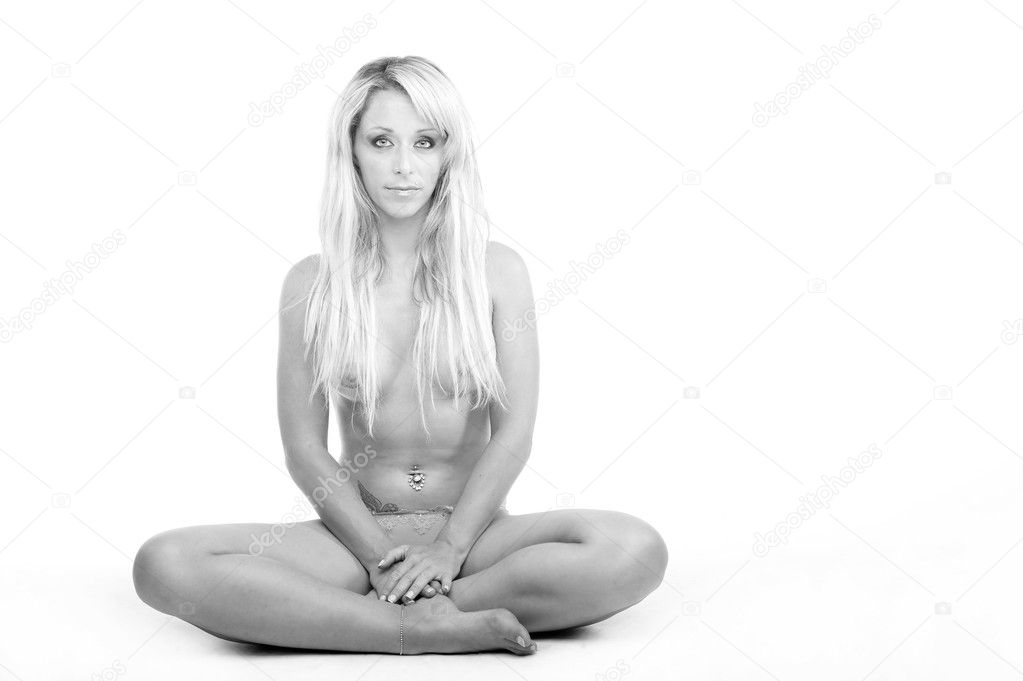Blond female seated in meditation position looking calm
