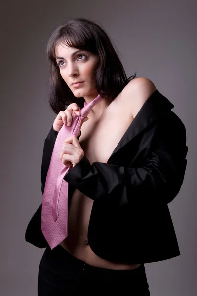 Sensual executive woman in black suit and tie — Stock Photo, Image