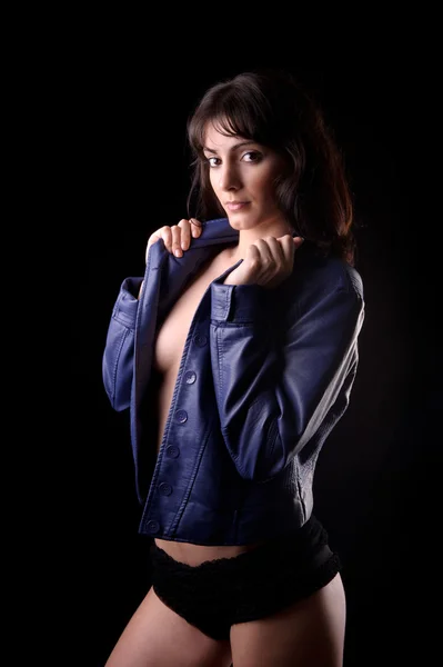 Sensual brunette woman wearing a blue leather jacket — Stock Photo, Image