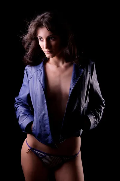 Sensual brunette woman wearing a blue leather jacket — Stock Photo, Image