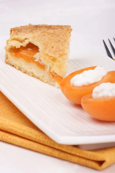 Slice of apricot tart served on a white plate — Stock Photo, Image